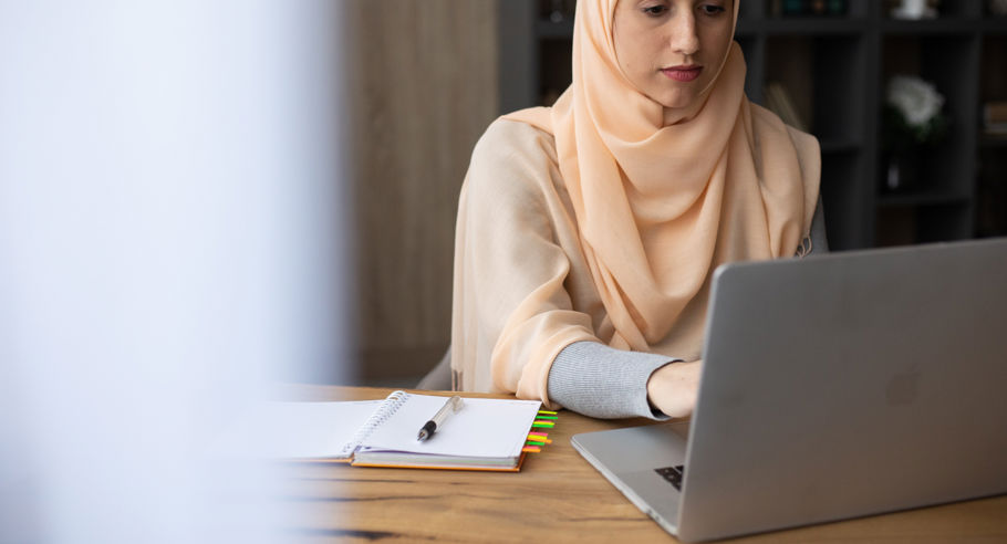A woman sitting with a laptop