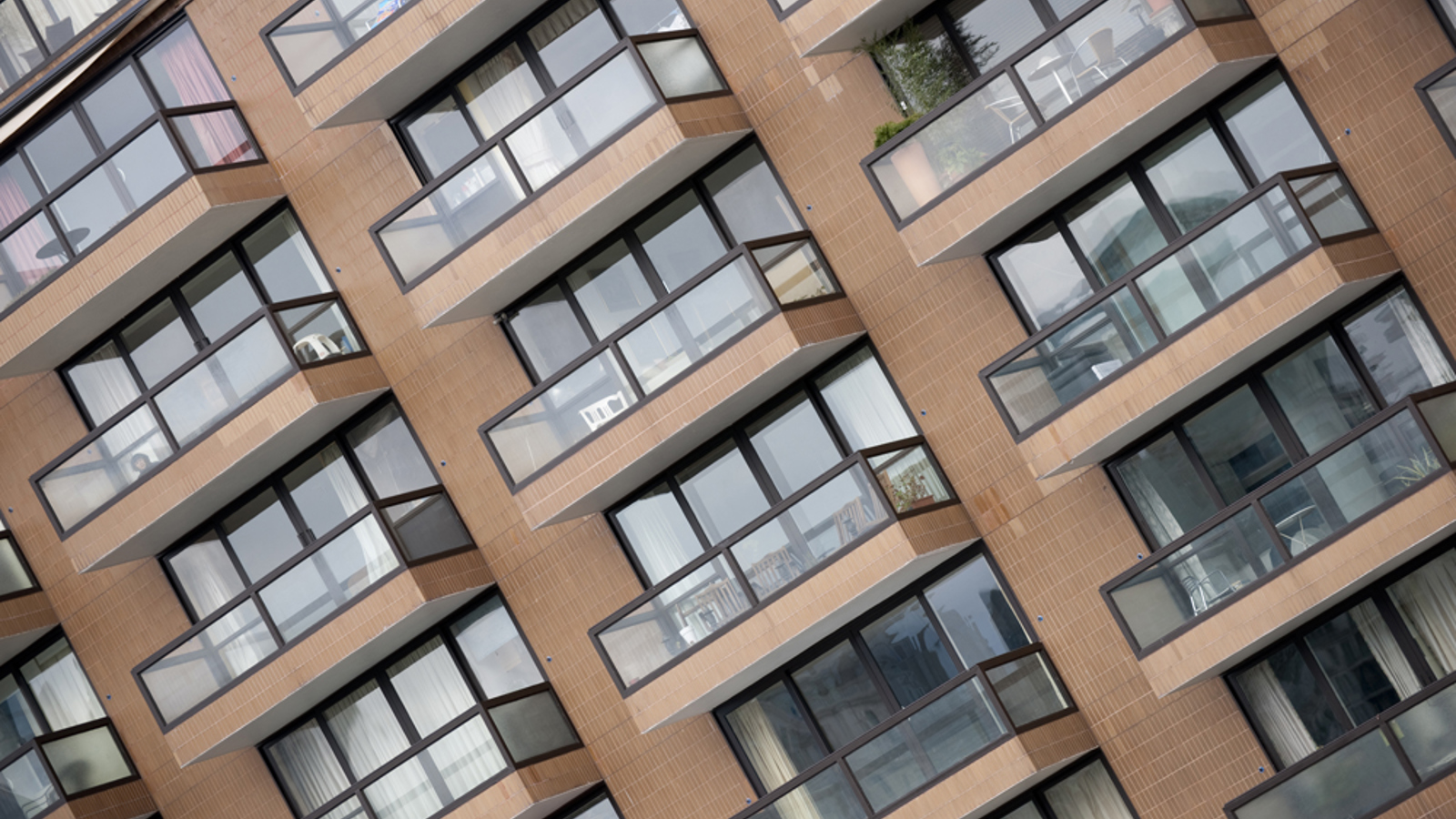 A tilted image capturing the balconies of an apartment building