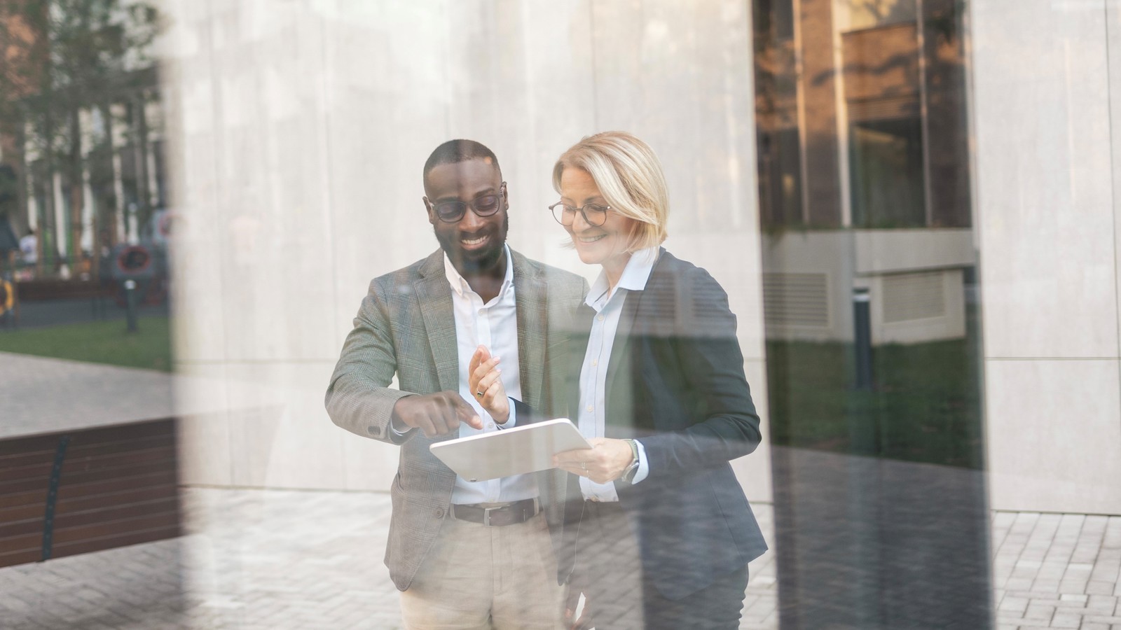 A smiling man and woman are looking at a document together