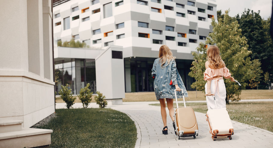 Two Beautiful Girls Standing By Airport